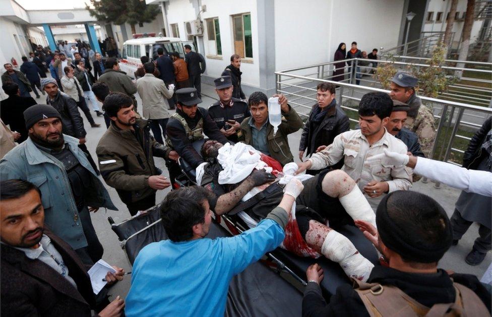 Men transport an injured person to a hospital after a suicide attack in Kabul, Afghanistan on January 10, 2017.