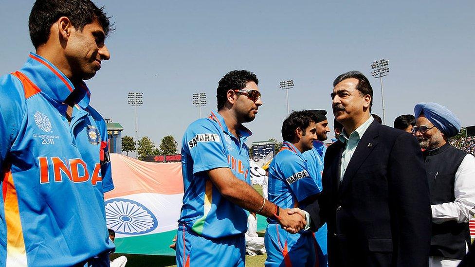 Prime Minister Syed Yusuf Raza Gilani of Pakistan shakes hands with Yuvraj Singh of India as Prime Minister Manmohan Singh of India looks on prior to the start of the 2011 ICC World Cup