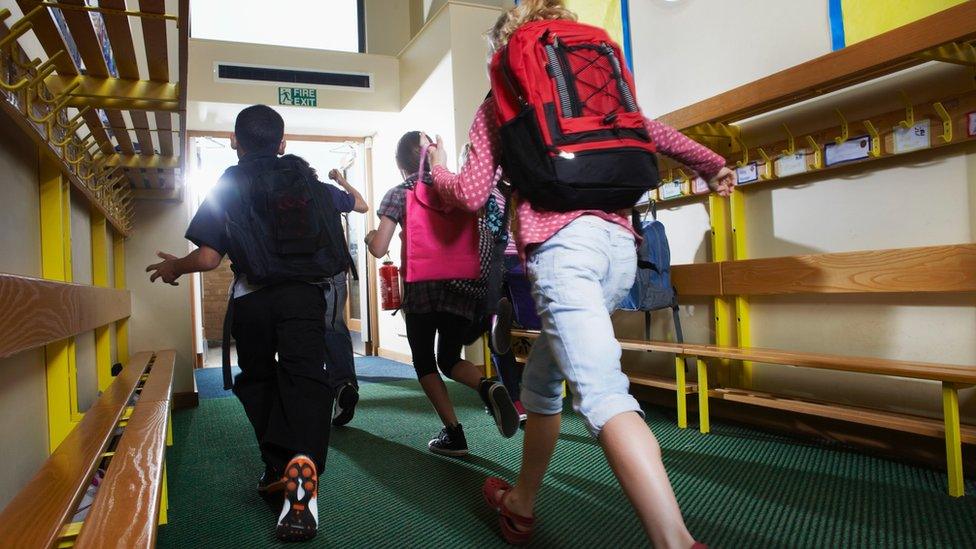 Children running out of a school