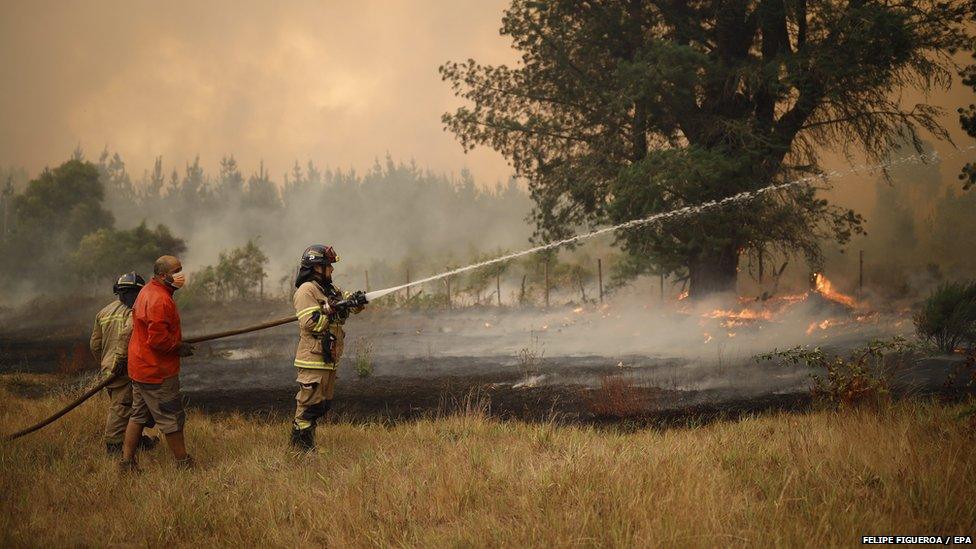 emergency servcies battle wildfires in chile with local residents