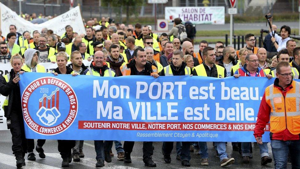 Harbour workers, storekeepers and residents march to participate in a human chain protest demonstration against the migrant situation in Calais