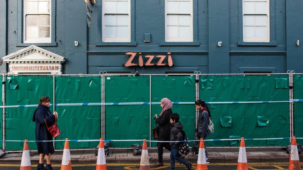 People walk past a Zizzi restaurant which has been closed as investigations continue into the poisoning of Sergei Skripal