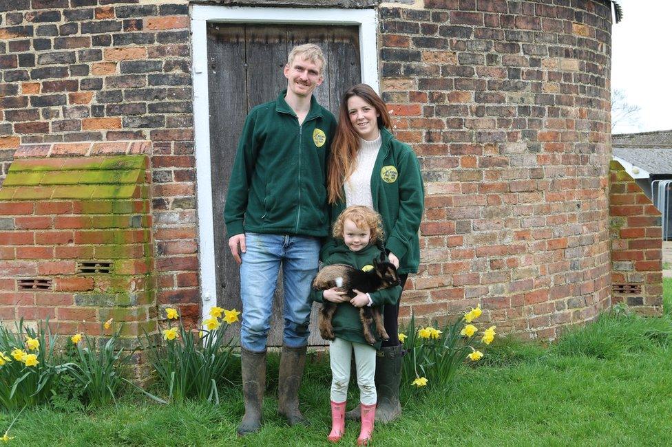 The Briggs family with the baby goat