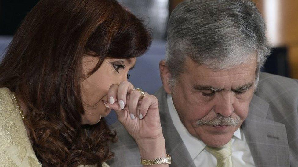 Argentina's President Cristina Fernandez de Kirchner (L) whispers to Argentine Minister of Planning and Public Investment Julio De Vido during a ceremony for the160th anniversary of Buenos Aires Stock Exchange in Buenos Aires on August 20, 2014