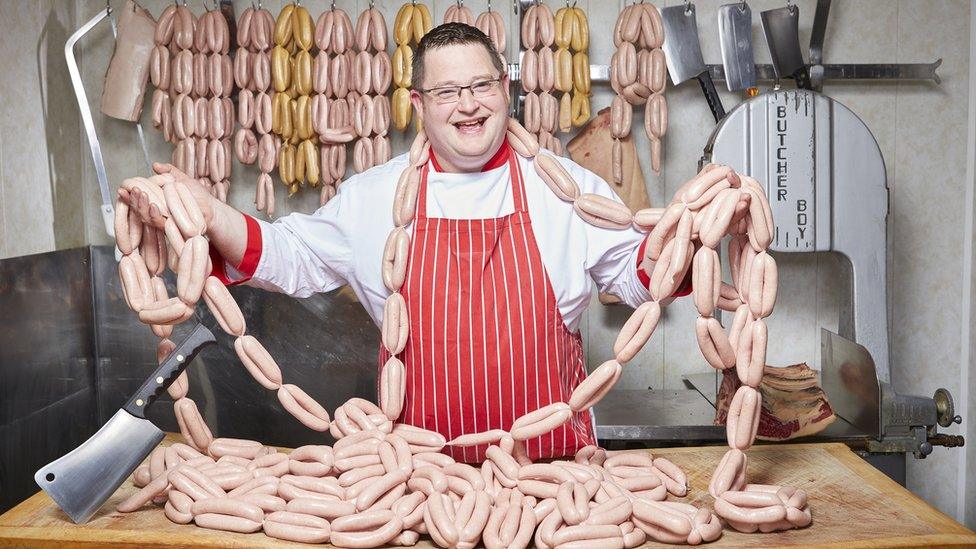 Barry John Crowe, with the record for most sausages made in a minute.