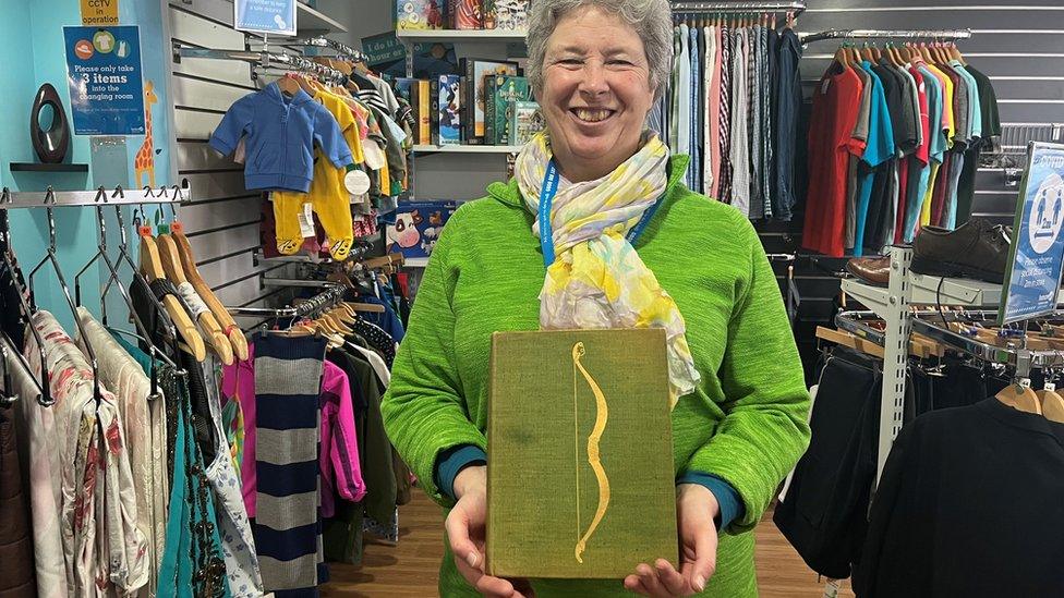 Francoise Curtis holding the copy of James Joyce's classic, Ulysses