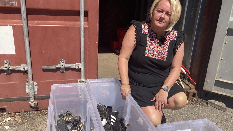 Johanna Cotterrall with boxes of boots