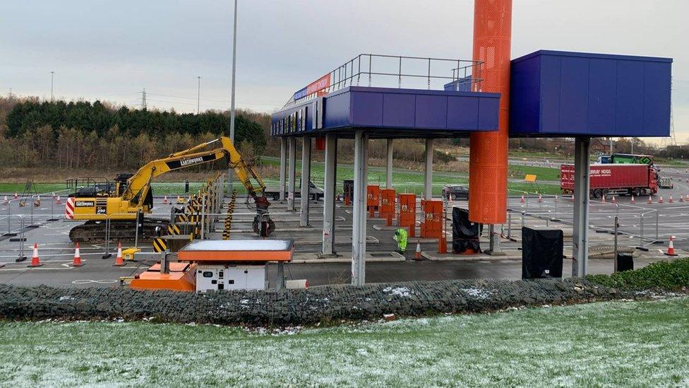 Digger working to remove the toll booths