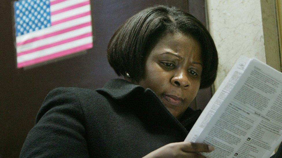 T. McKnight looks over forms as she prepares to file for a tax extension inside the James A. Farley post office building in the early evening April 17, 2007 in New York City.