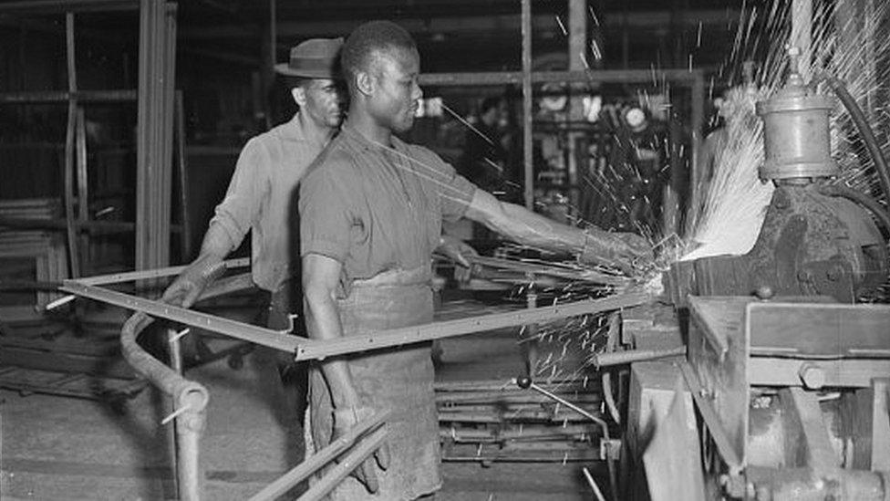 A West Indian worker making window frames