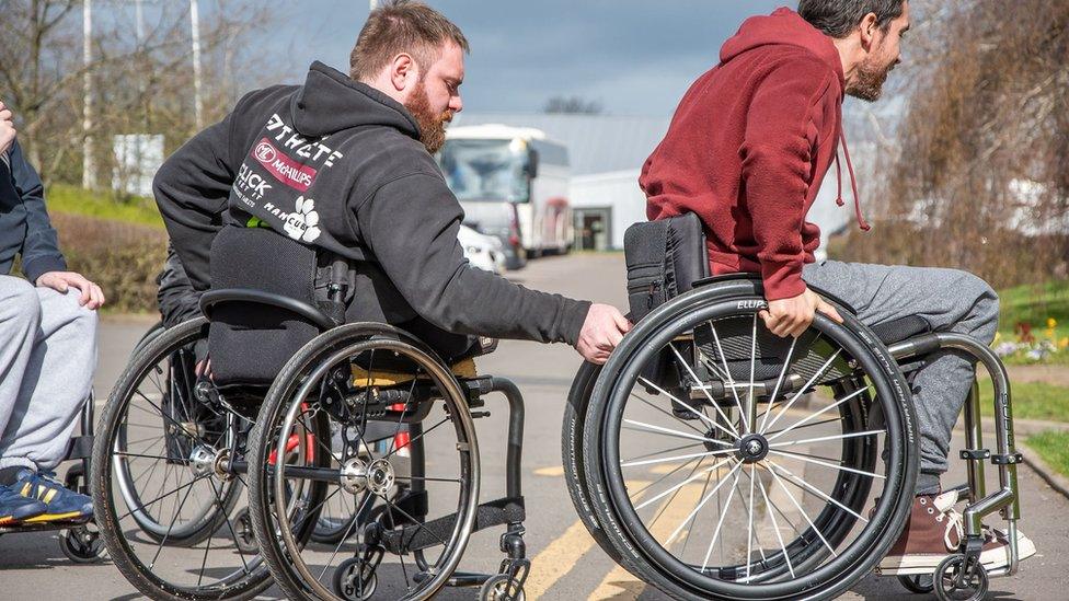 Wheelchair users practising on kerbs