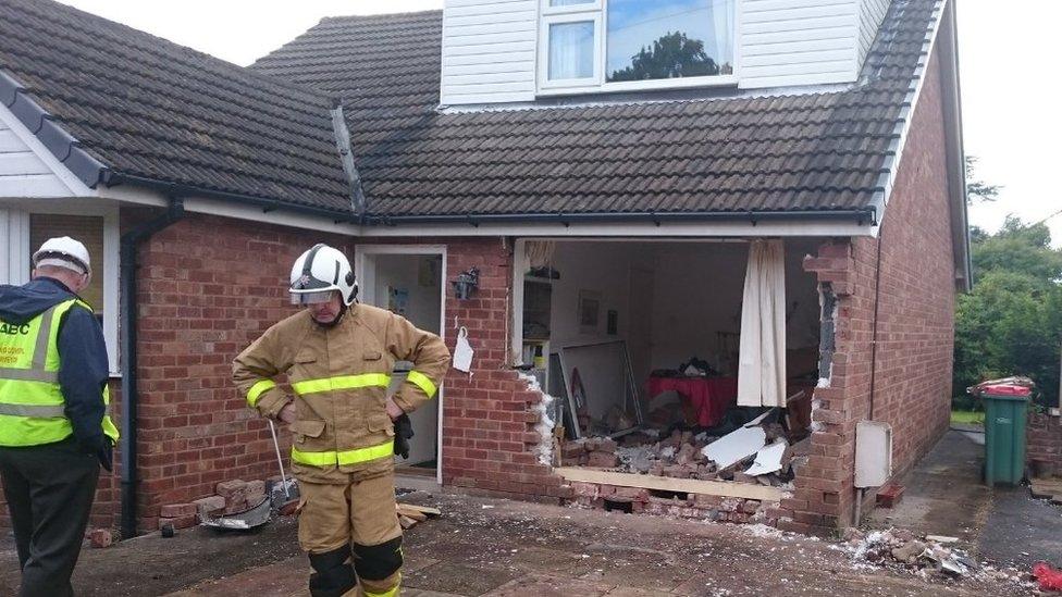 Damage after car hits house