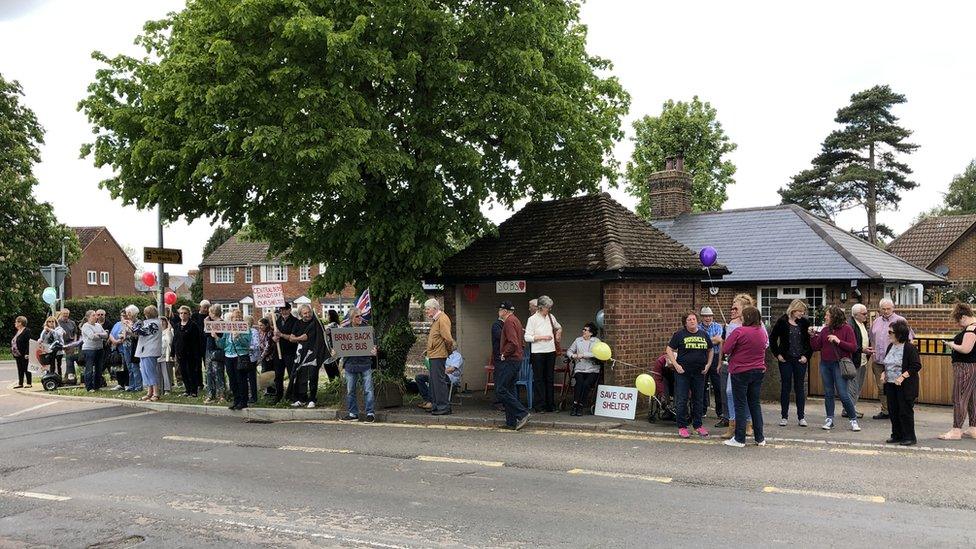 People outside a bus stop