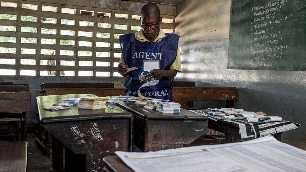 Electoral official arranges ballots at a polling station in Kinshasa on 31 December 2018