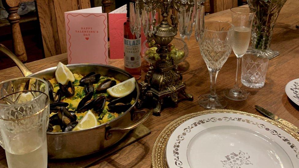 A dinner table with full wine glasses and champagne flutes