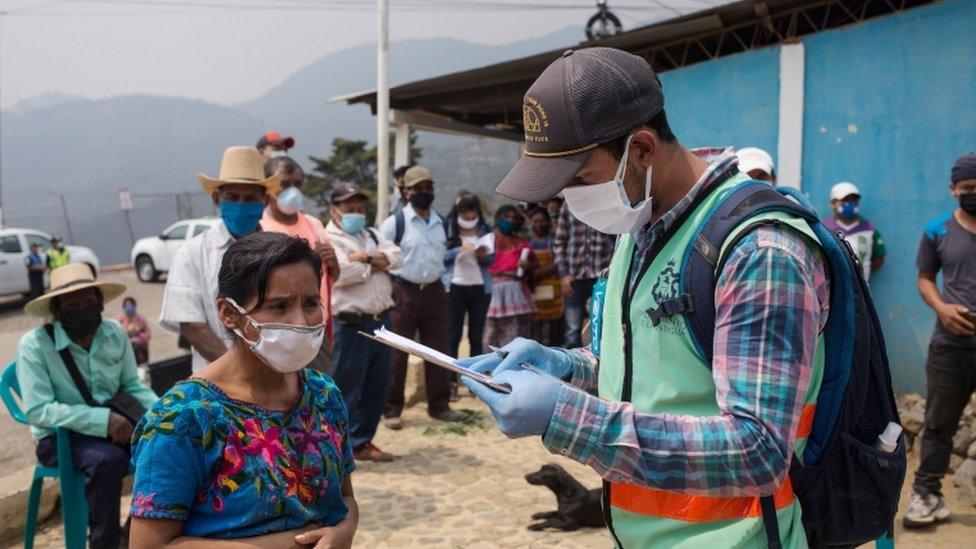 People wait in line to receive aid supplies from the municipality after the restriction measures ordered by the government to prevent the spread of coronavirus at El Hato, in Antigua Guatemala, Guatemala, 25 April 2020.