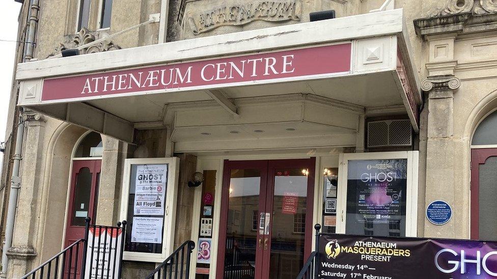 The front of the Athenaeum Theatre in Warminster with red doors and bath stone front