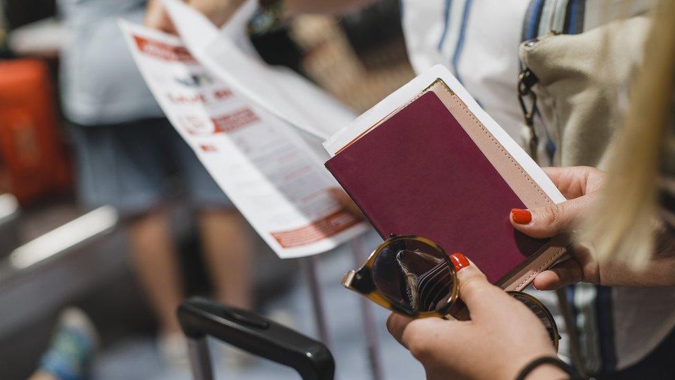 Woman holds passport