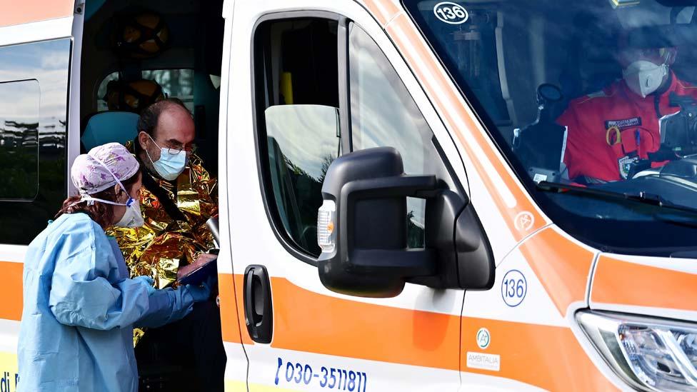 A man arrives in an ambulance at the a pre-triage medical tent in front of the Cremona hospital, in Cremona, northern Italy, on 4 March 2020