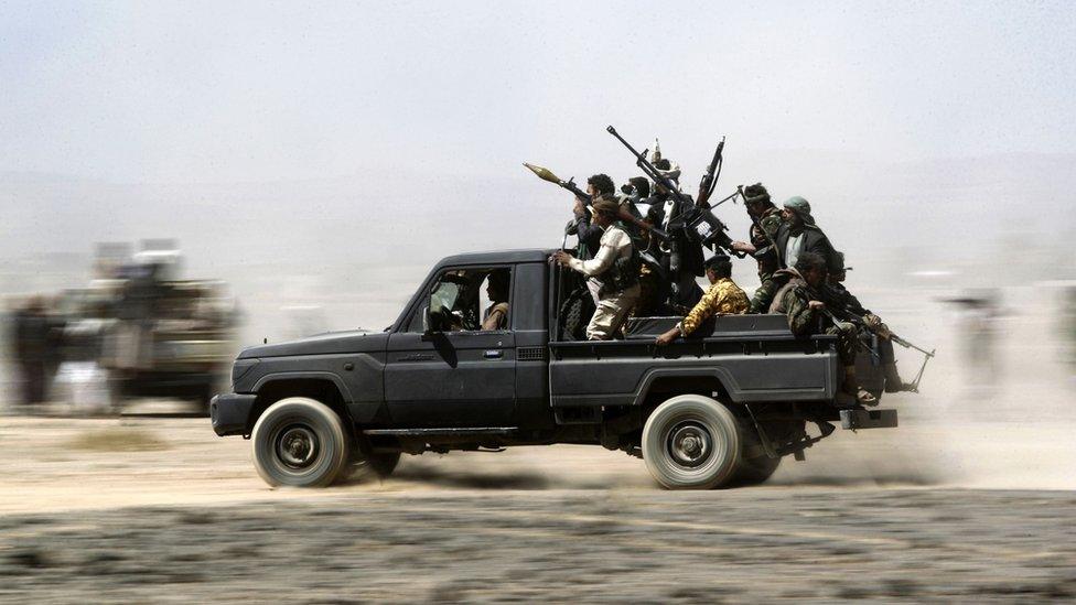 Armed Yemeni tribesmen loyal to the Shiite Huthi rebels sit in the back of an armed vehicle during a gathering to mobilise more fighters into several battlefronts on November 1, 2016