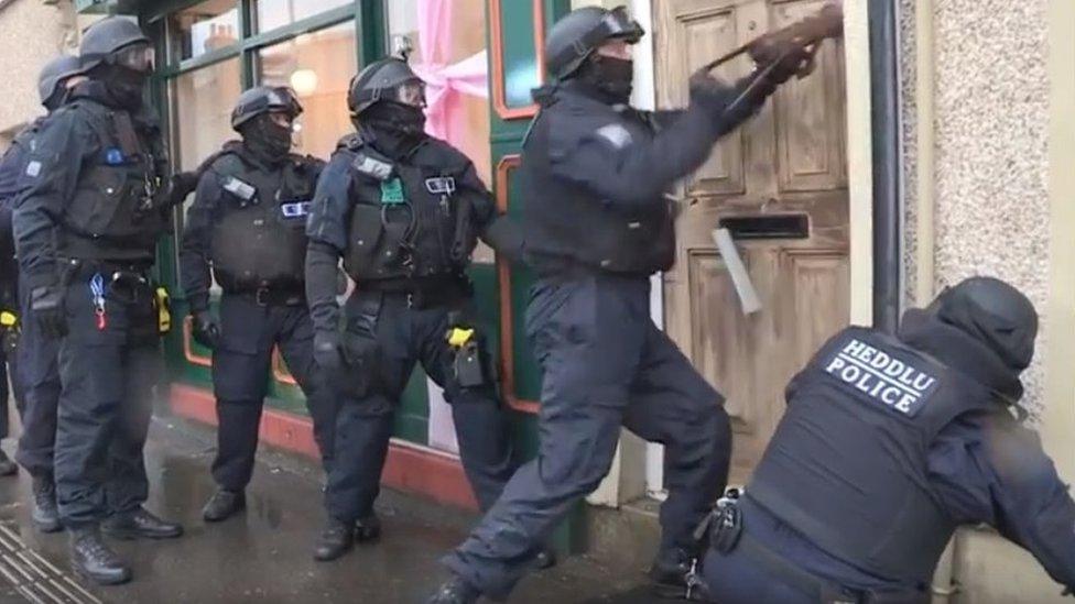 Police carrying out one of several raids in south Wales