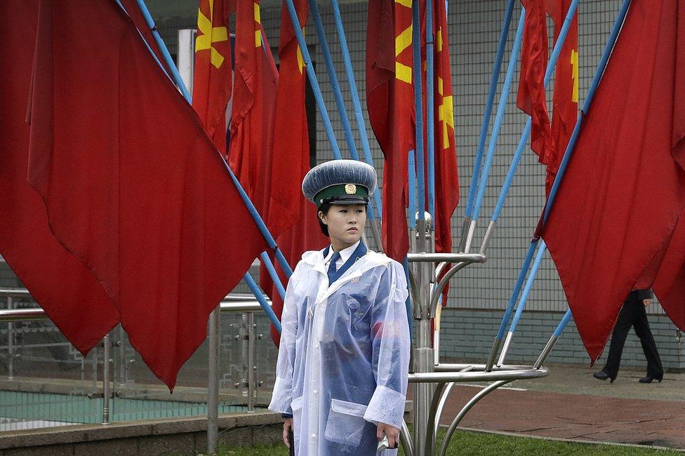 North Korean traffic police woman stands in front of Workers" Party flags decorating the streets on Friday, 6 May 2016, in Pyongyang, North Korea.