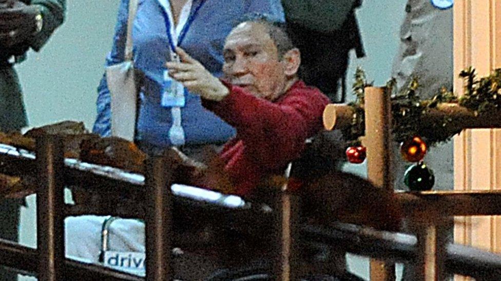 Picture taken on December 11, 2011 of former Panamanian dictator Manuel Noriega (red) upon arrival at the Renacer prison, 25 km south east of Panama City