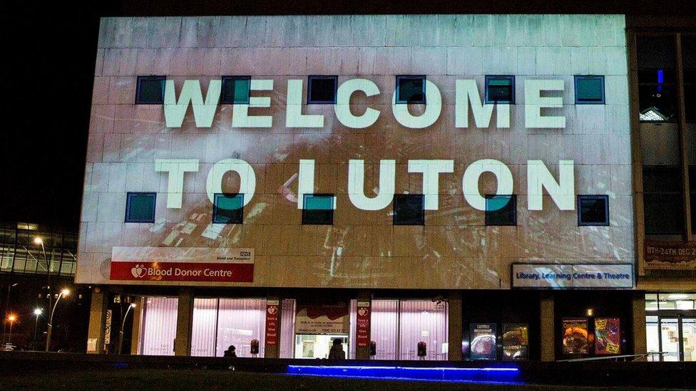 Welcome to Luton projected onto a building in the centre of Luton