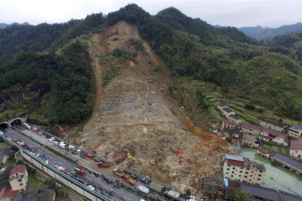 A aerial view shows rescuers searching for survivors among debris at the site of a landslide in Yaxi township of Lishui, Zhejiang province