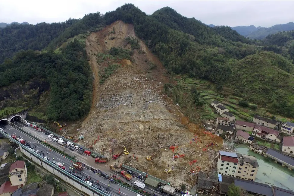 The landslide has created a small barrier lake (below right), hampering rescue efforts
