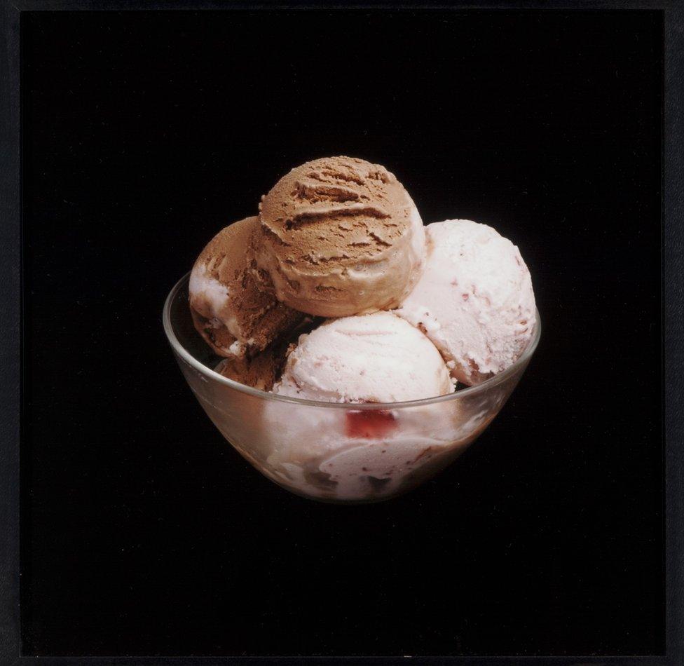 A bowl of chocolate and strawberry ice cream