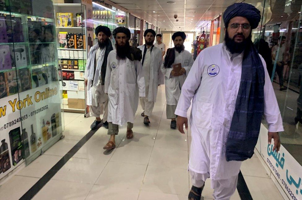 Maulvi Fatih leads his team of Vice and Virtue officials at a Kabul mall