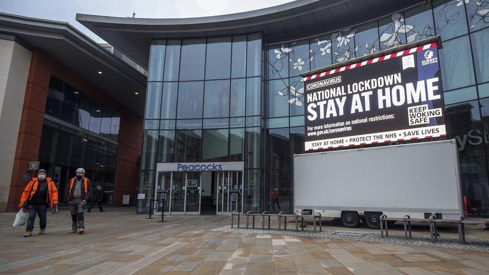 The UK government's stay-at-home message shown on an electric billboard outside a shopping centre