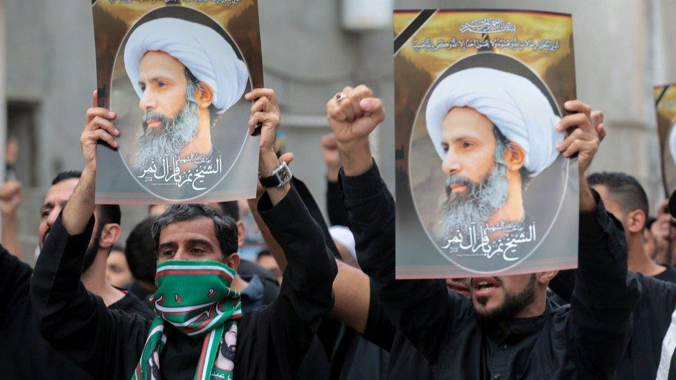 Protesters hold up posters showing the executed Shia cleric Sheikh Nimr al-Nimr at a protest in Qatif, Saudi Arabia (8 January 2016)