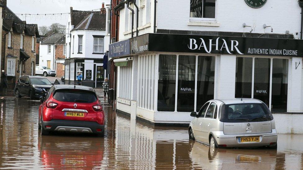 Cars sit in the receding flood water in Tenbury Wells, Worcestershire, in the aftermath of Storm Dennis.