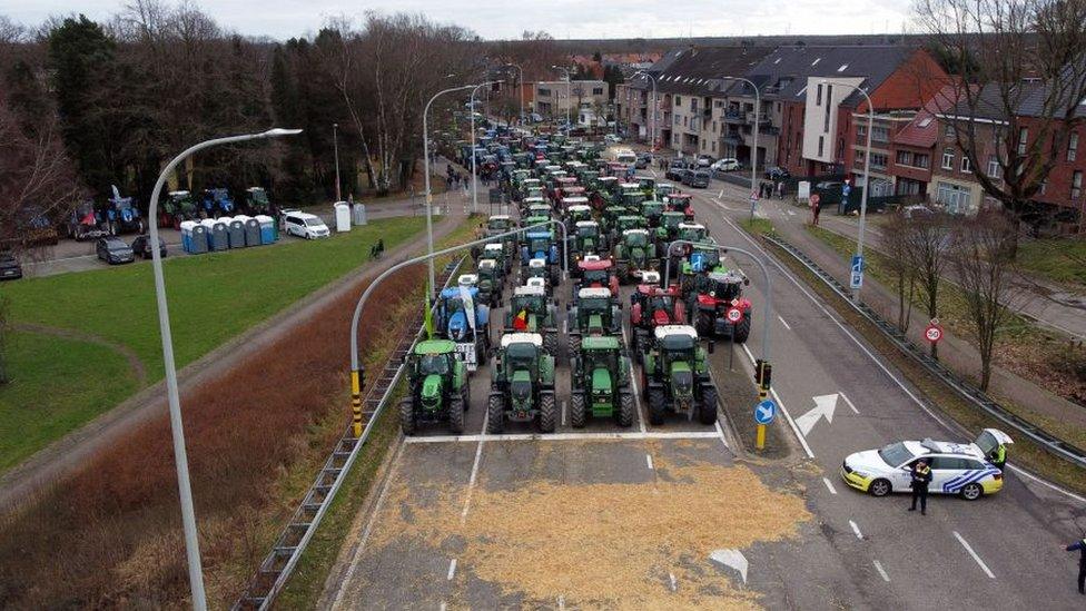 This aerial drone image shows tractors lined up on the road, a farmers protest organized by Boerenbond and Groene Kring in Genk, Friday 09 February 2024.