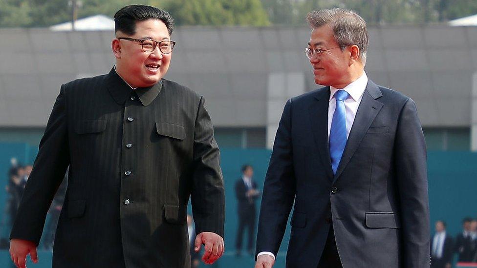 North Korean leader Kim Jong Un (L) and South Korean President Moon Jae-in (R) walk after the official welcome ceremony for the Inter-Korean Summit on April 27, 2018 in Panmunjom, South Korea