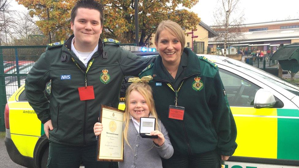 Six-year-old Lilly-Mae with call handler Andrew Garven and paramedic Anya