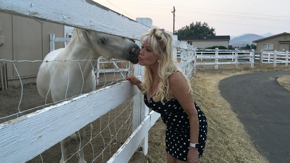 Air Force Amy visiting the ponies behind the ranch