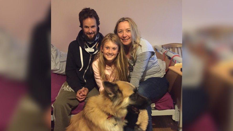 Mr Rudd with his partner and daughter, and family dog in the foreground