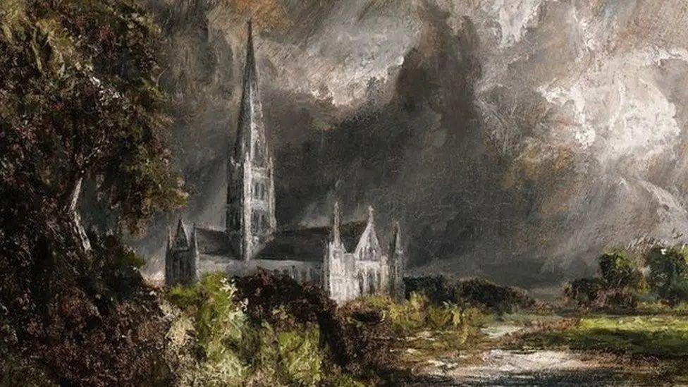 A painting of Salisbury Cathedral, by John Constable. It is a dark painting, with the cathedral depicted in front of a dark, cloudy sky. Trees and other nature can be seen around the building. 