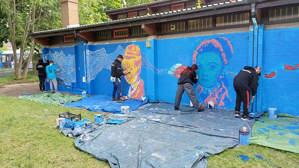 Students painting the mural