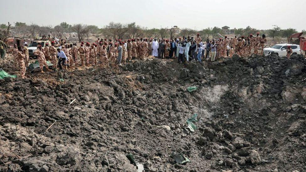 Soldiers looking at a crater at the army deport in N'Djamena lasts at a military ammunition depot in N'Djamena, Chad June 19, 2024.