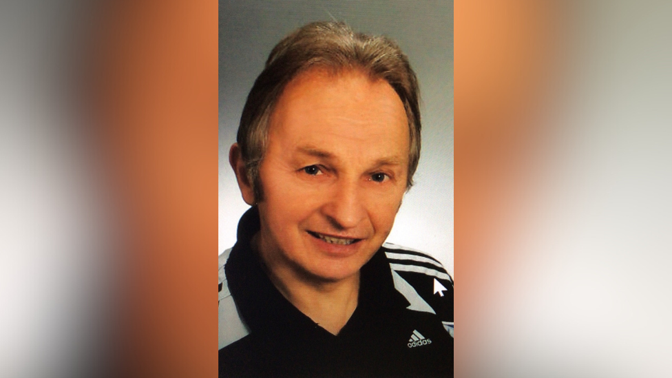 Headshot of a man wearing an Adidas polo shirt smiling at the camera