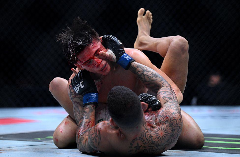 Lone'er Kavanagh grapples with Felipe dos Santos during the MMA flyweight fight at The O2 Arena on 22 March in London.