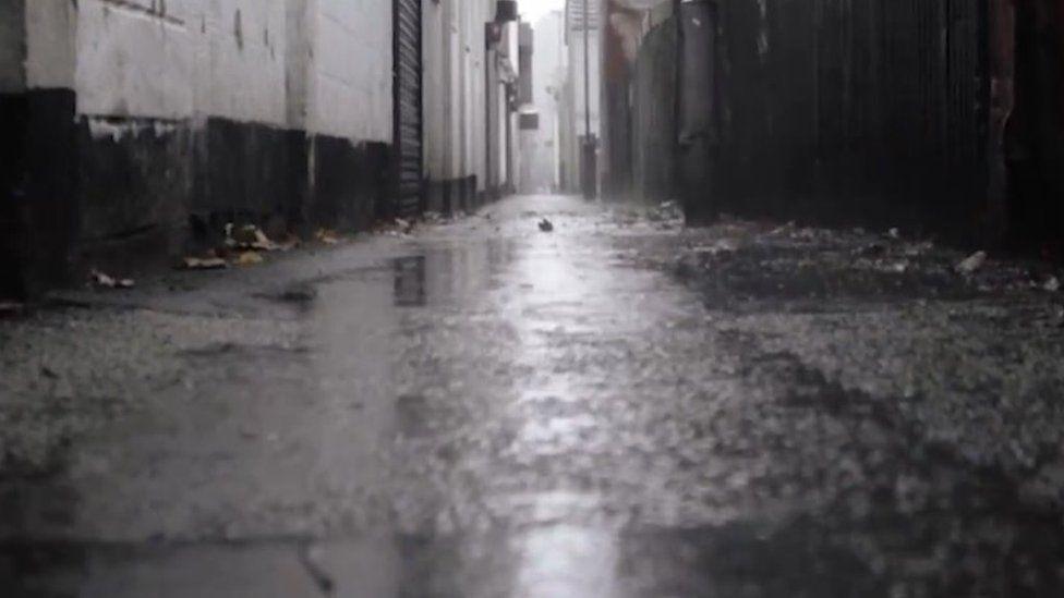 Puddles on a path in an alleyway