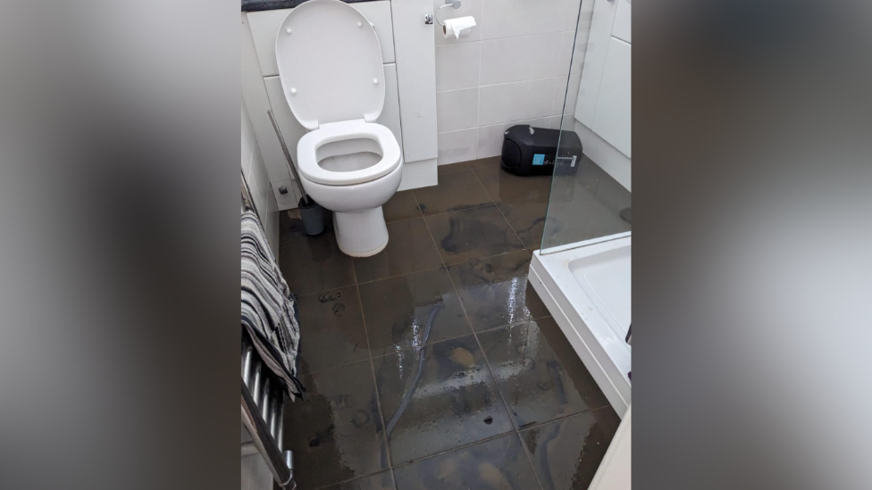 A bathroom with mud all over the floor