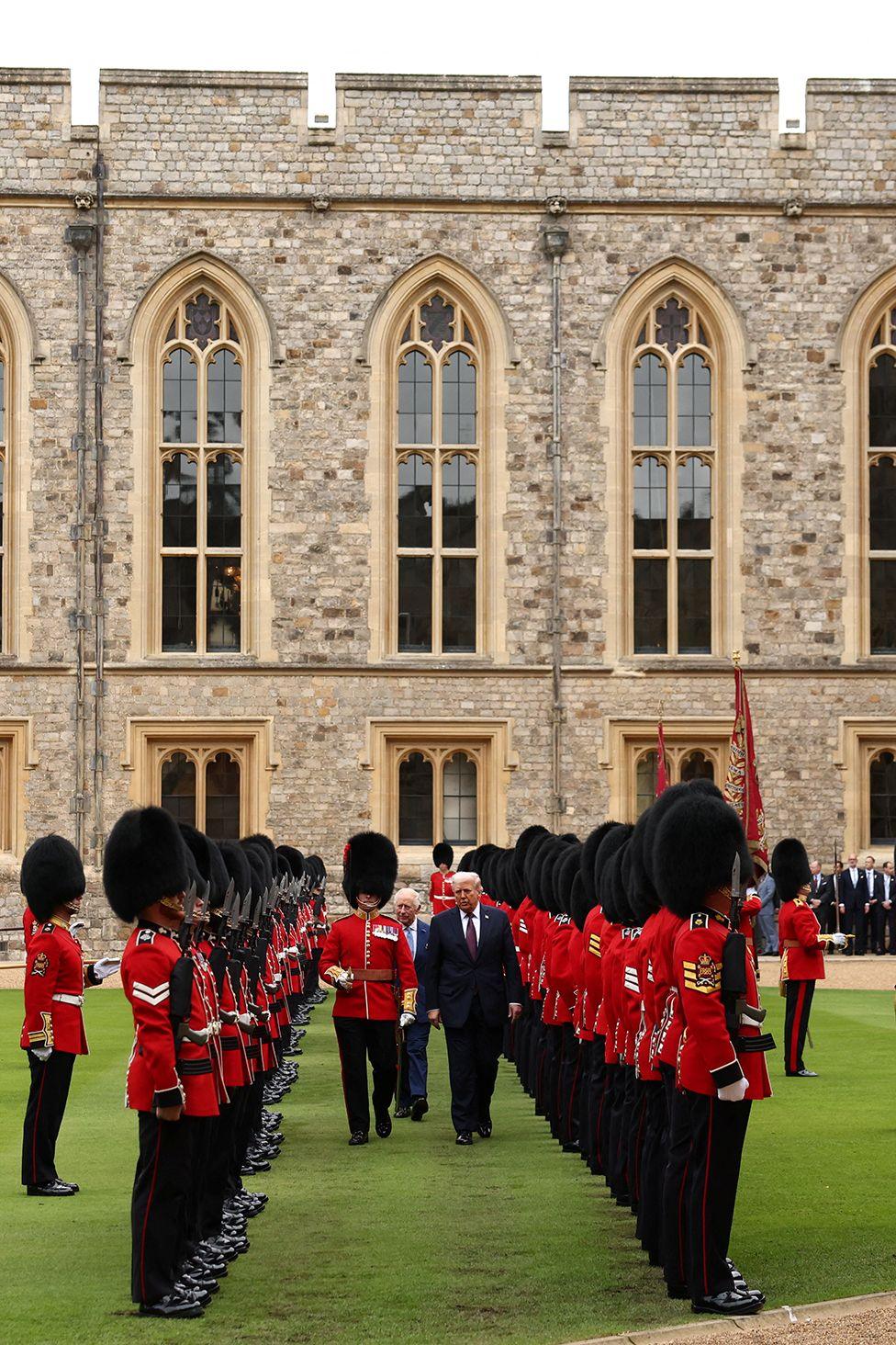 U.S. President Donald Trump and Britain's King Charles inspect the Guard of Honour as they attend a welcome ceremony during Trump's state visit, at Windsor Castle, in Windsor, Britain, September 17, 2025. 

