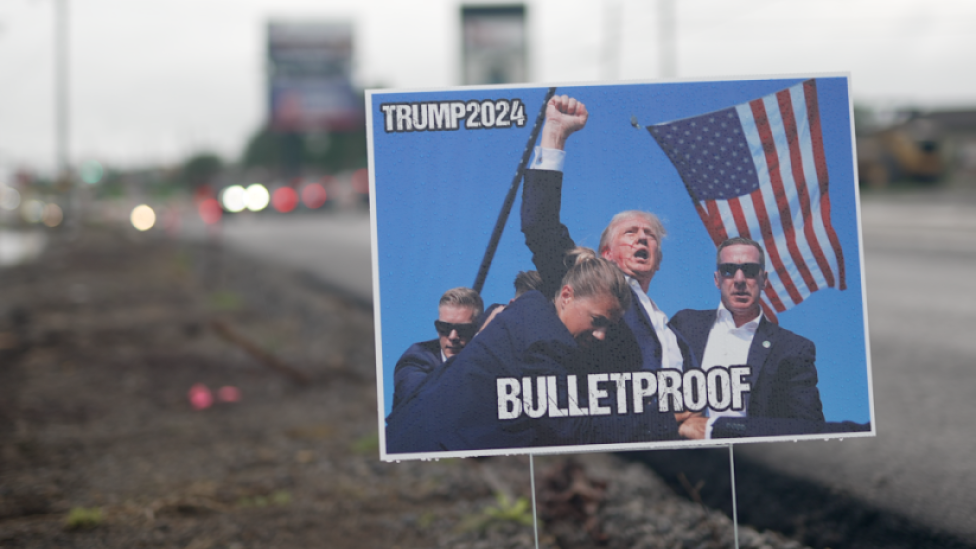 A poster of Trump with blood on his face and fist raised, with words "BULLETPROOF"