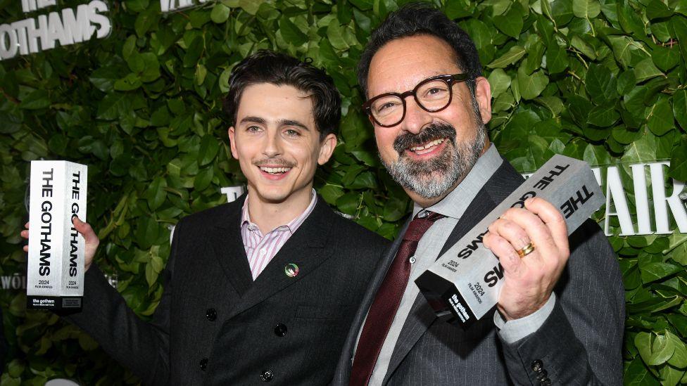 Timothée Chalamet, James Mangold pose with their Visionary Tribute awards for "A Complete Unknown" at the 34th Annual Gotham Awards held at Cipriani Wall Street on December 02, 2024 in New York